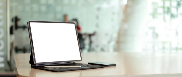 Cropped shot of portable workspace  with digital tablet on white desk with copy space in co-working space, clipping path