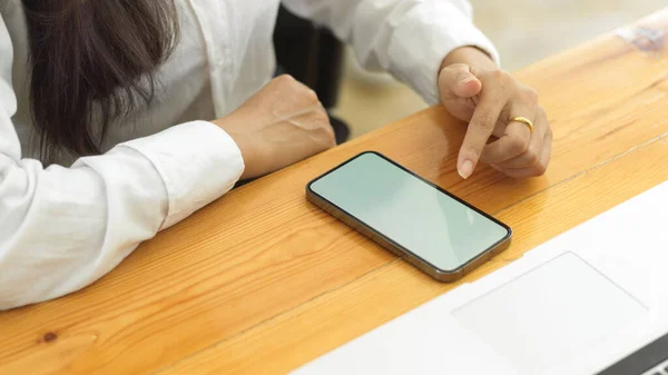 スマートフォンを使った女性の手の上からの眺め ワークスペースの電話画面でのタッチ — ストック写真