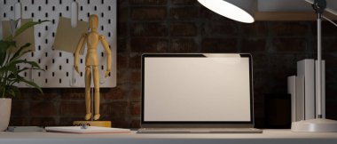 Vintage red brick working room with laptop mockup under light from table lamp, wooden figure, house plant, shelf, dark workspace, 3d rendering, 3d illustration clipart