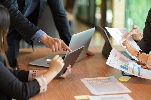 Cropped image of business group consulting and managing business project together in meeting room