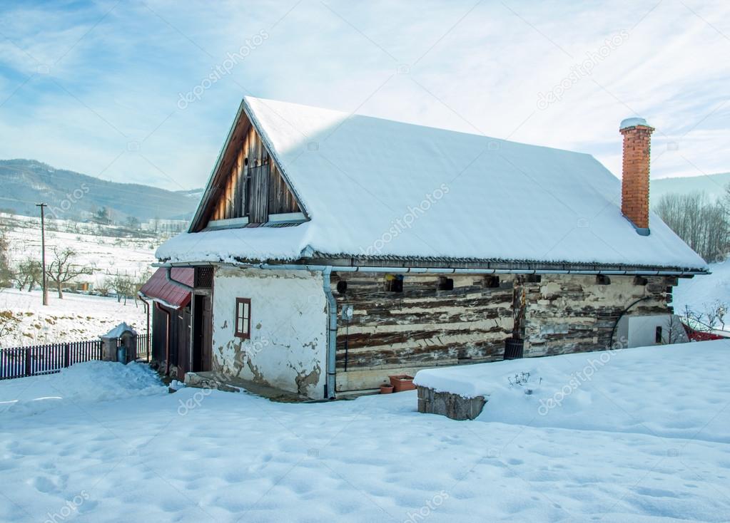 Wooden Cottage in Winter Landscape
