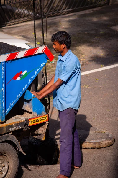 Chennai, Tamil Nadu, India - Nov 28 2020: Chennai City Metro water supply and sewage board worker cleaning up the underground drainage. Desilting of sewage pipes using machine. — Stock Image Chennai Tamil Nadu India Nov 2020 Chennai City Metro Water Stock Picture