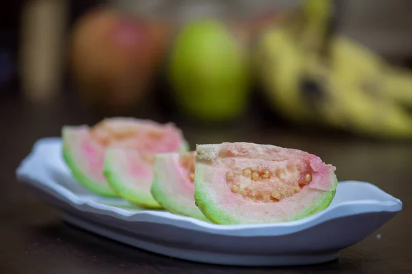 Slices of guava fruit in a plate. Guava is a tropical fruit which are rich in dietary fiber and vitamin C