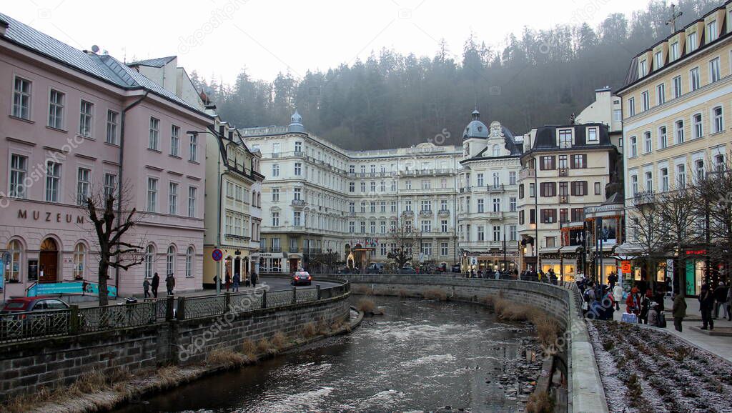The Tepla River in the resort area of the town, iconic 18th-century Grandhotel Pupp in the background, Karlovy Vary, Czech Republic - January 1, 2020