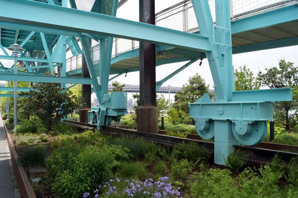 Decommissioned crane ramp at Domino Park retained for a decoration, detail of the rail track and rolling foot of the crane, Brooklyn, NY, USA - May 25, 2020