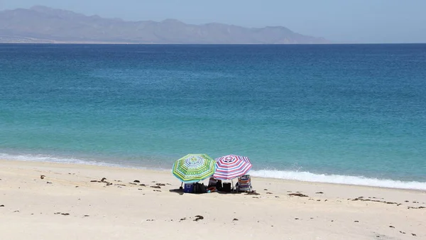 Cortes Denizi kıyısında iki plaj şemsiyesi, Punta Arena de La Ventana, BCS, Meksika - 1 Mayıs 2021