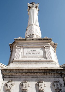 Base of Column of Pedro IV, details, stone carving and inscriptions, monument to King Peter IV in the center of Rossio Square, installed in 1870, Lisbon, Portugal - July 8, 2021