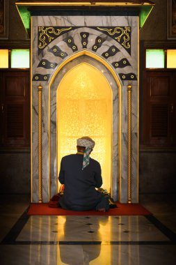 muslim man having worship and praying for allah blessing in islam ceremony in mosque during islamic ramadan period clipart