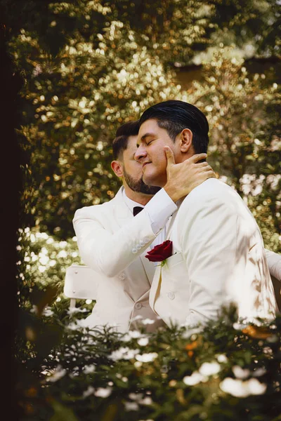 caucasian lgbtq gay marriage couple having romantic moment together after wedding ceremony. Concept of LGBTQ same sex relation