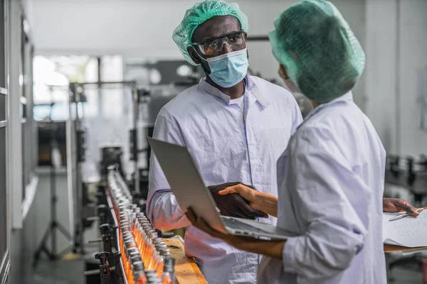 industrial background of beverage factory production line supervisor and worker working together in beverage production line during processing in beverage manufacturing factory