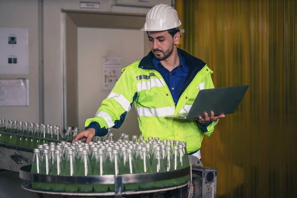 industrial background of beverage factory production line engineer and supervisor checking production line during processing in beverage manufacturing factory