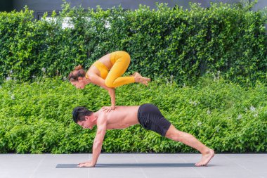 Spor giyim sektöründe Kafkas ve Asyalı sporcu çiftler spor salonunda yoga ya da spor salonunda birlikte yoga yapıyorlar. Atletik çift sağlıklı ve sağlıklı yaşam tarzı.
