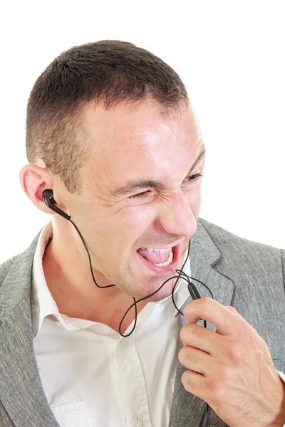 Young man using earbuds shouting on microphone — Stock Photo, Image