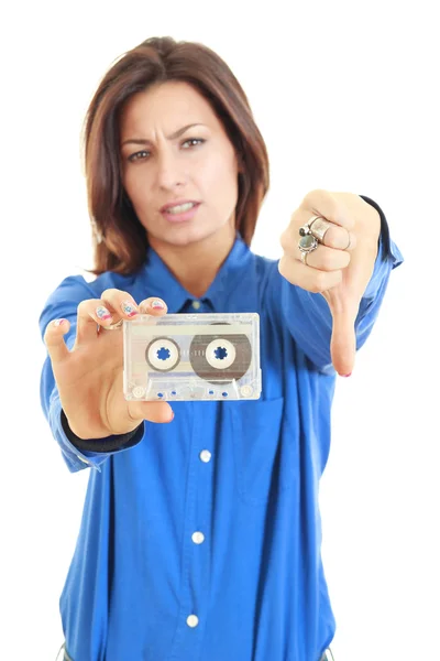 Girl dislikes old audio cassette — Stock Photo, Image