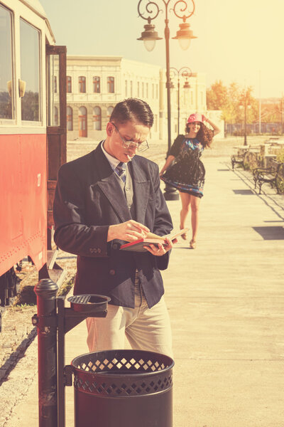 couple outside retro train coach have a romantic encounter 