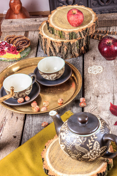 Romantic composition of cups and cookies on wooden table