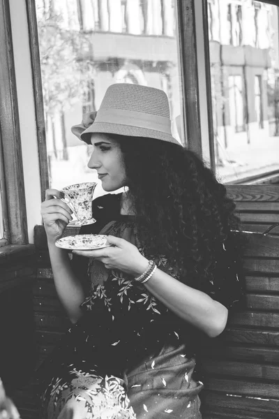 Hoto of girl in a wagon train drinking coffee or tea while looki — Stock Photo, Image