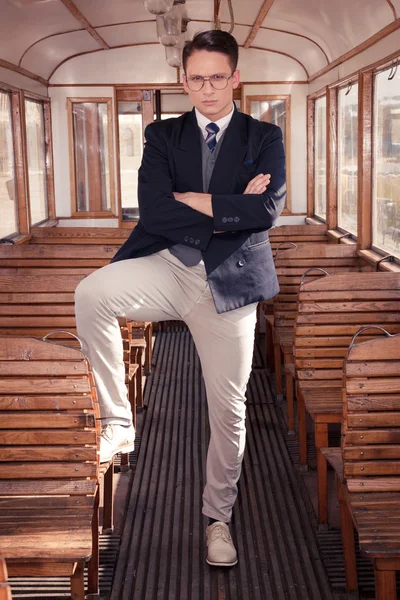 Man standing in an old train wooden wagon or carriage and lookin — Stock Photo, Image