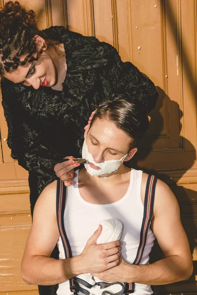 Man with shaving foam on his face and towel around his neck siti — Stock Photo, Image