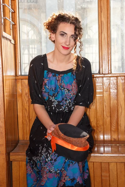 Retro image of young woman sitting in wagon train or tram — Stock Photo, Image