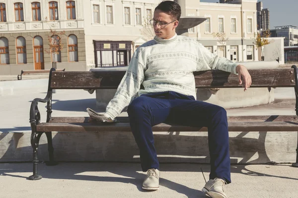 Vintage photo of man with glasses in white sweater reading newsp — Stock Photo, Image