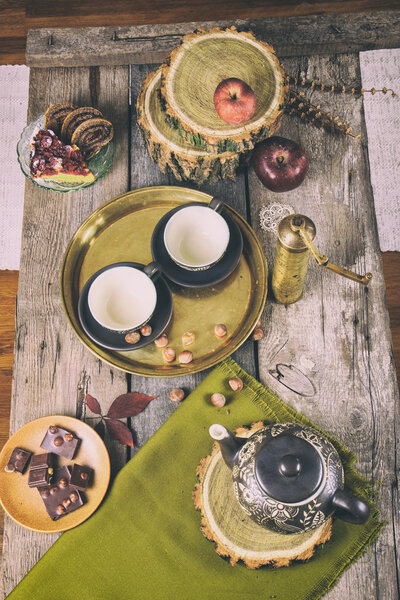 Retro kitchen table with tea set cookies and chocolate