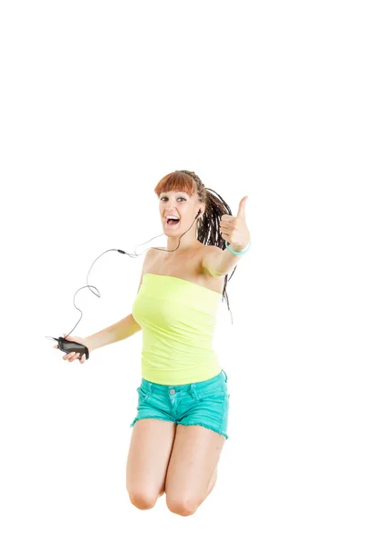 Girl jumping in the air with headphones showing thumbs up — Stock Photo, Image