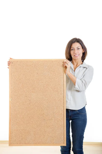 Woman holding a wooden board cork isolated on white background — Stock Photo, Image