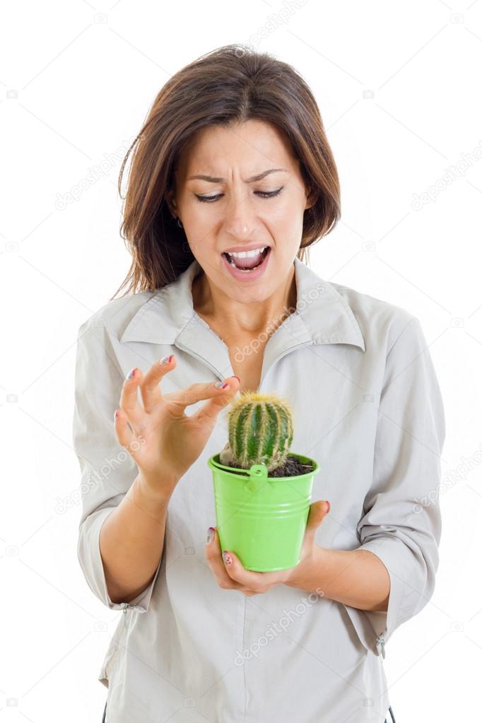 woman holding cactus plant and stabbed her finger with painful f