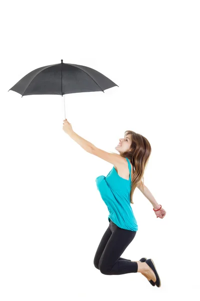 Girl in blue t-shirt and black tights with umbrella jumping — Stock Photo, Image