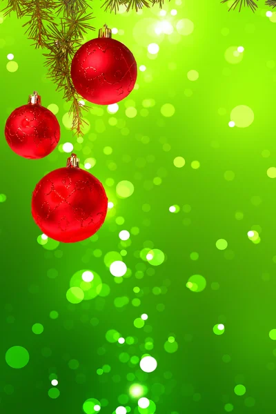 Christmas red balls with green fir tree on colorful green bokeh — Stock Photo, Image