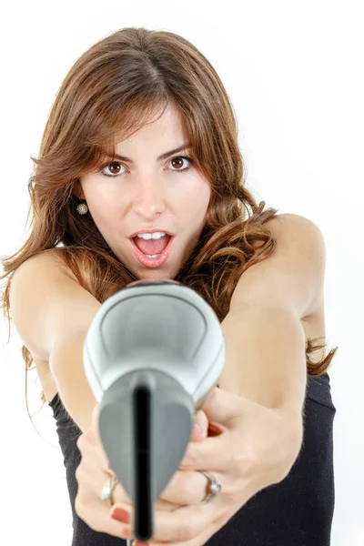 Hairdresser holding hairdryer like gun and pointing at camera wi — Stock Photo, Image