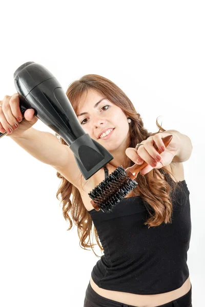 Young woman with blow dryer and hairbrush working — Stock Photo, Image