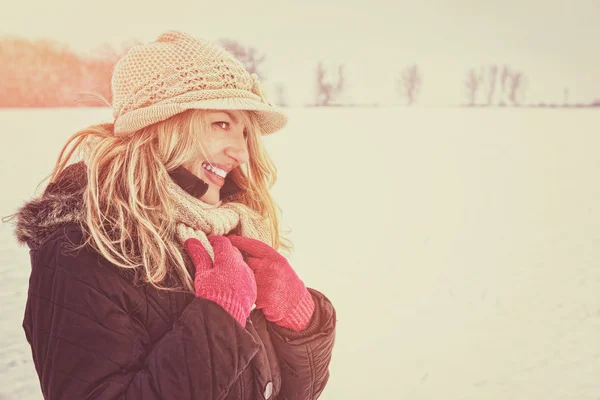 Happy woman in snow looking aside or to someone — Stock Photo, Image