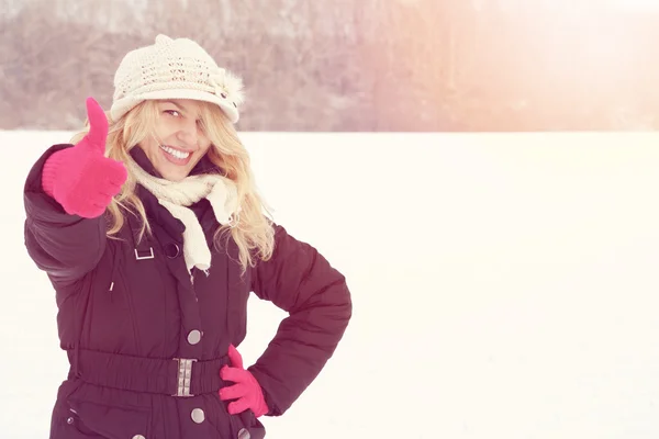 Winter happy woman in snow looking up at camera — Stock Photo, Image