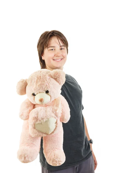 Boy smiling and holding teddy bear toy as gift for girl — Stock Photo, Image