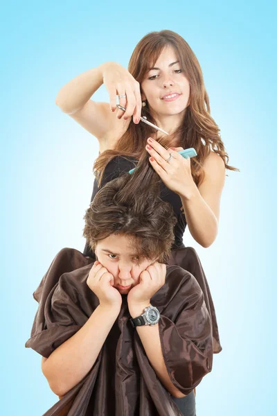 Boy with face expression with long hair at hairdresser — Stock Photo, Image