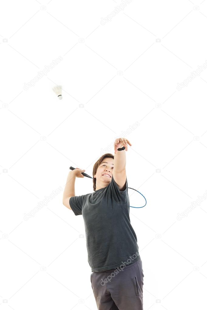  boy smiling and holding badminton racket and trying to hit ball