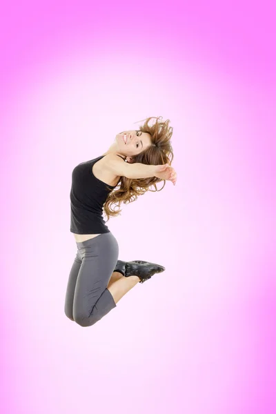 Full body of cheerful young pretty fit girl or woman jumping — Stock Photo, Image