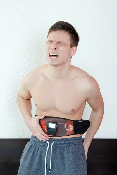 Shocked and stressed handsome young man with an electrical devic — Stock fotografie