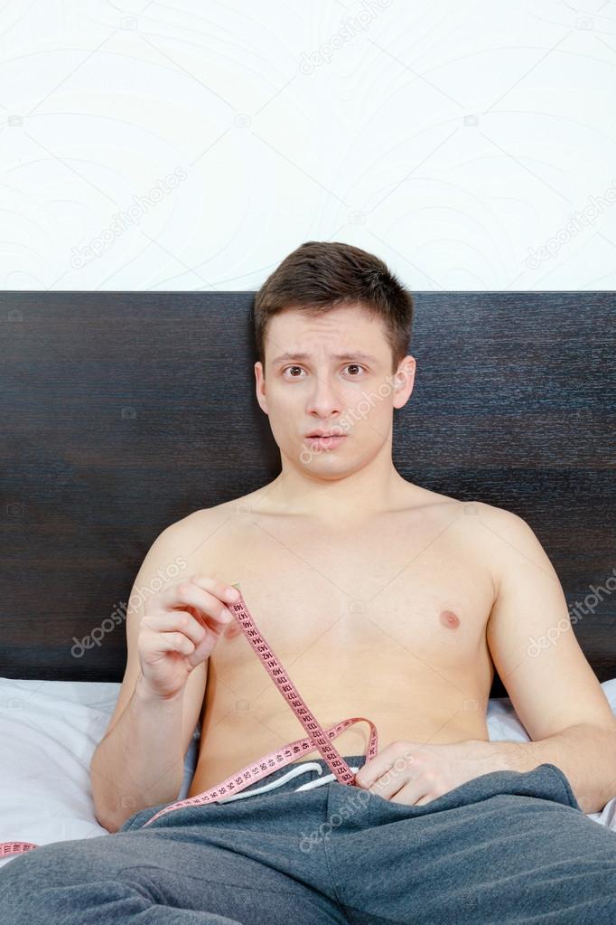 Frightened and insecure male model showing length of his pride.