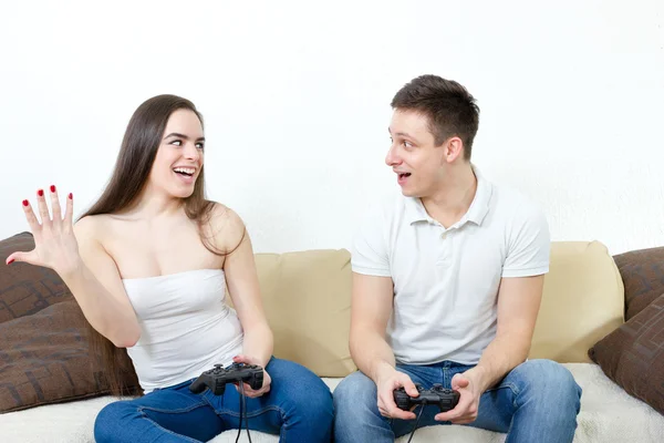 Casal sentado na sala de estar e jogar jogos de vídeo no console o — Fotografia de Stock