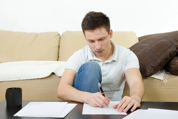 Handsome man with papers and cup of coffee. — Stock Photo, Image