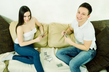 Young beautiful adult couple looking at camera feeling happy