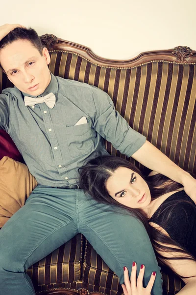 Attractive couple, pair of lovers at ancient living room sitting — Stock Photo, Image