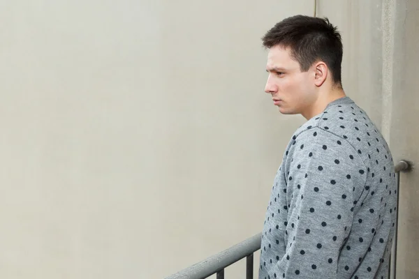 Young man at balcony in depression sufferin — Zdjęcie stockowe