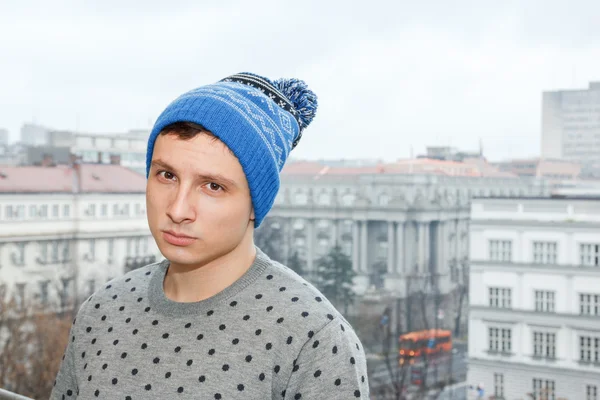 Person on terrace looks to somber and desolate city after rain — Stock Photo, Image