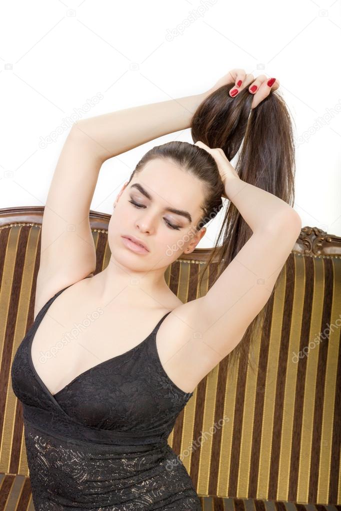 beautiful sexy person  indoor lifts up hair