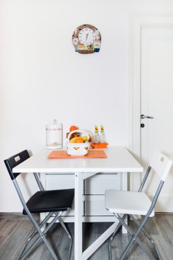 Kitchen with Fresh Fruit Basket on the White Table With Chairs