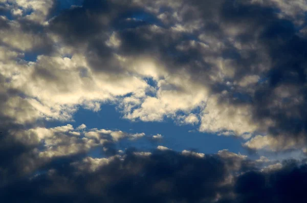 Big white cloud and light ray behind cloud with blue sky